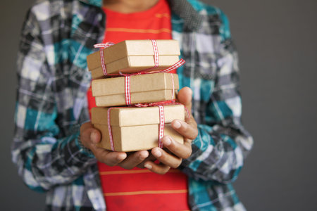 child hand hold homemade gift box.