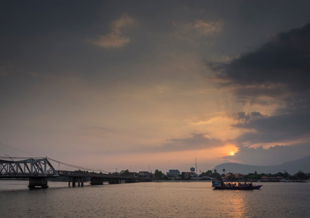 landmark old bridge and river at sunset in kampot cambodiaの写真素材