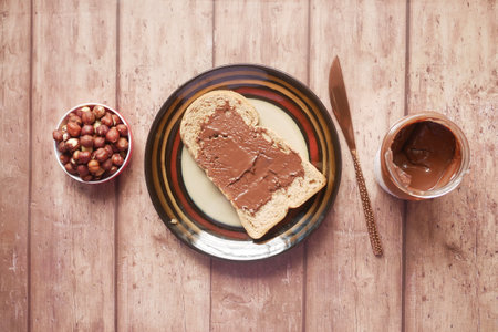 Chocolate Hazelnut Spread on a Bread on Tableの写真素材