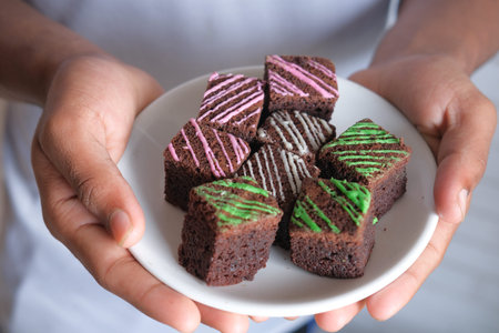 slice of homemade brownie on plate on table .
