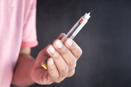 hand hold Insulin pens against black background .の写真素材