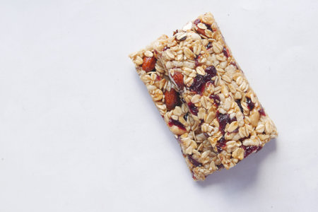 Almond , Raisin and oat protein bars on table .