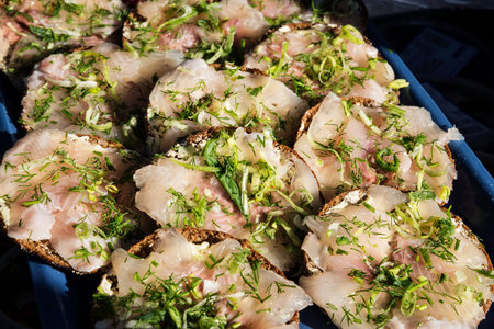 fresh marinated scandinavian herring fillet sandwich snacks with dill in helsinki market