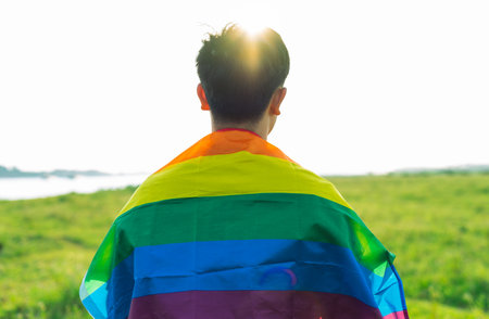 Abstract silhouette of gay man on shoulder is lgbt flagの写真素材