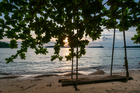 wood swing on empty beach in koh ta kiev paradise island near sihanoukville in cambodiaの写真素材