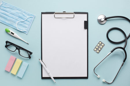 overhead view healthcare accessories near clipboard with plank paper spectacles background . Resolution and high quality beautiful photoの写真素材