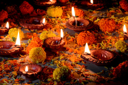 Clay diya lamps lit during Diwali Celebration. Greetings Card Design Indian Hindu Light Festival called Diwaliの写真素材