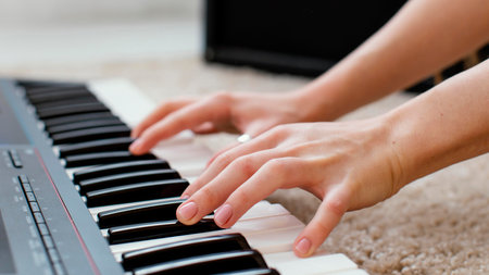 close up female musician playing piano keyboardの写真素材