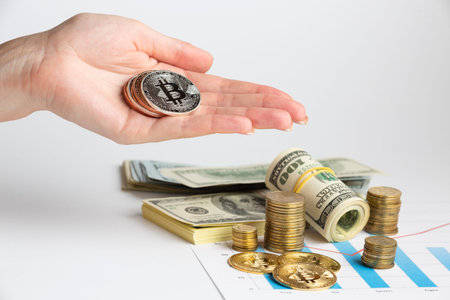 hand holding bitcoin money stack