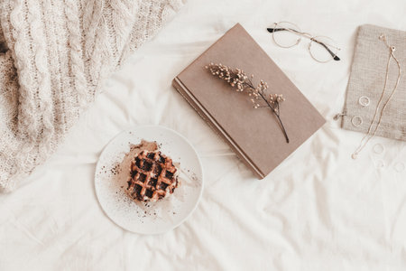 book with herb near bun plate other things bedsheetの写真素材