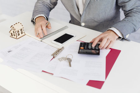 crop realtor counting with calculator. Resolution and high quality beautiful photo
