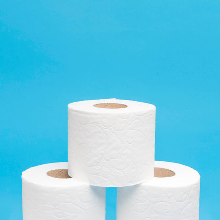 front view three stacked toilet paper rolls with copy space