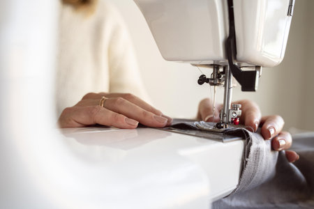 close up person using sewing machine. High quality beautiful photo concept