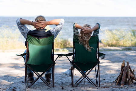 couple sitting chairs from shotの写真素材