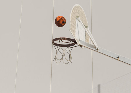 basketball falling hoop against wall
