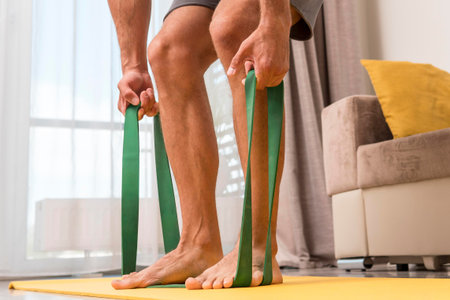 man working out home using elastic band