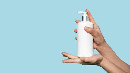 person holding bottle liquid soap with copy spaceの写真素材