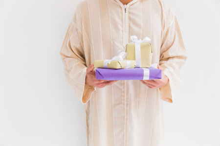 muslim man holding present boxesの写真素材