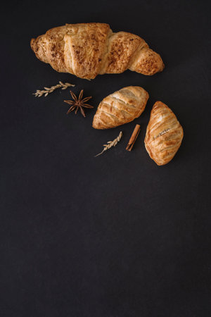 elevated view croissants spices grains black backgroundの写真素材