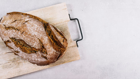 loaf rustic baked bread chopping board white background