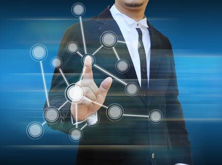 businessman pushing a touch screen interfaceの写真素材