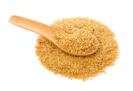 Flax seeds heap in wood spoon isolated on white backgroundの写真素材