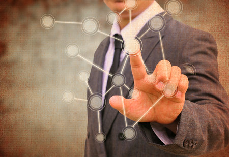 businessman pushing a touch screen interface in the old paperの写真素材