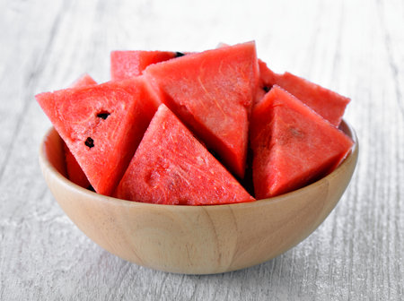 water melon in wood bowl on tableの写真素材