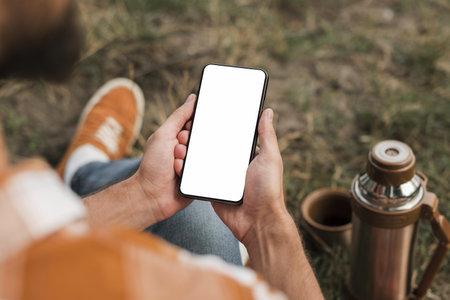 man holding smartphone while camping outdoors . High quality and resolution beautiful photo conceptの写真素材