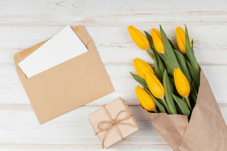 assortment yellow tulips with card envelopeの写真素材