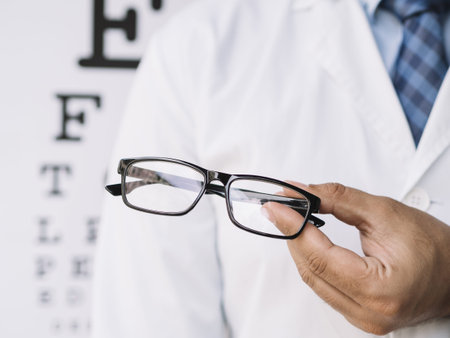male doctor holding pair eyeglasses his hands. High quality and resolution beautiful photo concept