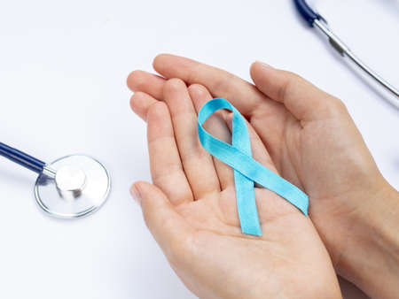 close up hands holding blue ribbon with stethoscope. High quality and resolution beautiful photo conceptの写真素材