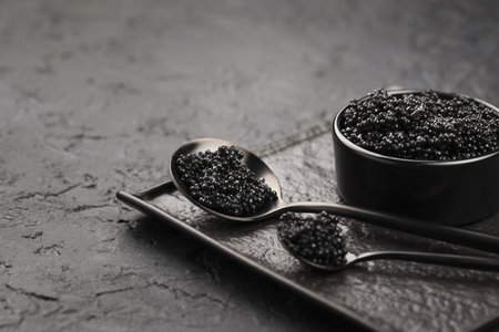 black caviar bowl with spoons ladle. High quality and resolution beautiful photo concept