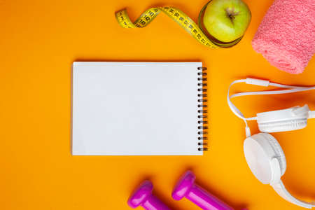 flat lay notebook apple yellow backgroundの写真素材