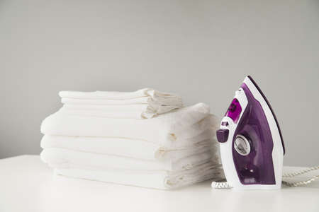 front view pile towels with iron. High quality beautiful photo conceptの写真素材