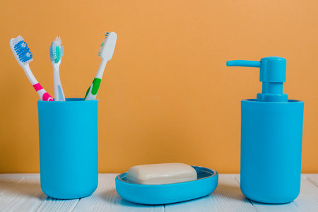 toothbrushes soap soap dispenser bottle white desk against wallの写真素材