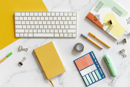 keyboard surrounded by colorful stationery . Resolution and high quality beautiful photo