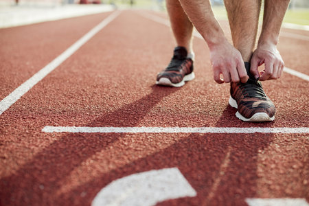 close up young woman tying sports shoe red race track. Resolution and high quality beautiful photo