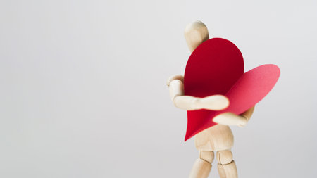 toy manequin holding heart with copy space. Resolution and high quality beautiful photoの写真素材
