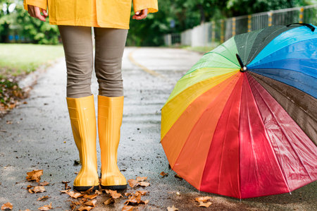 woman rain boots standing colorful umbrellaの写真素材