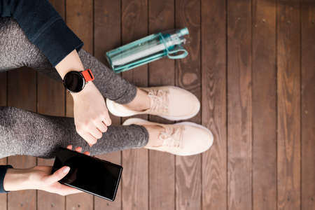 top view woman sportswear holding mobile phoneの写真素材