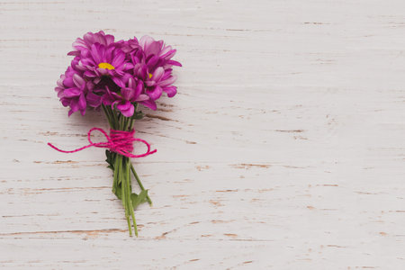 purple flowers tied white wooden surface. Resolution and high quality beautiful photoの写真素材