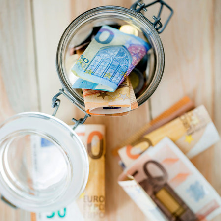 overhead view euro banknotes open glass jar
