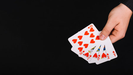 poker player s hand royal flush heart black background