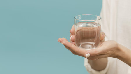 woman holding glass filled with water copy space. Resolution and high quality beautiful photoの写真素材