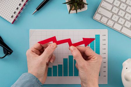 top view business items with growth chart hands holding arrow