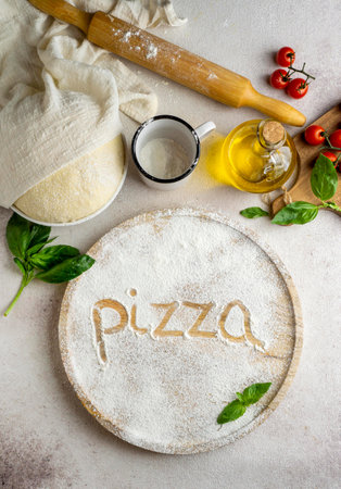 top view pizza dough with tomatoes word written flourの写真素材