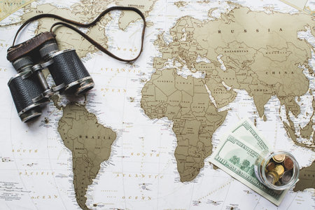 world map background money binoculars