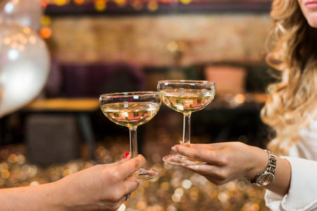 two female s hand toasting whiskey night club
