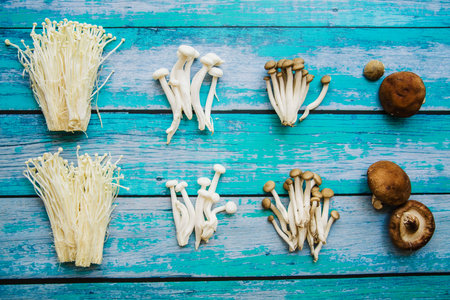 various types raw healthy mushrooms arranged old wooden table